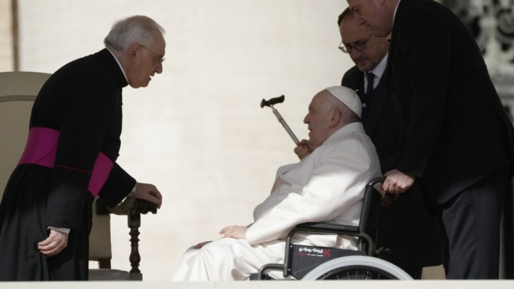 Antipope Bergoglio in a wheelchair.